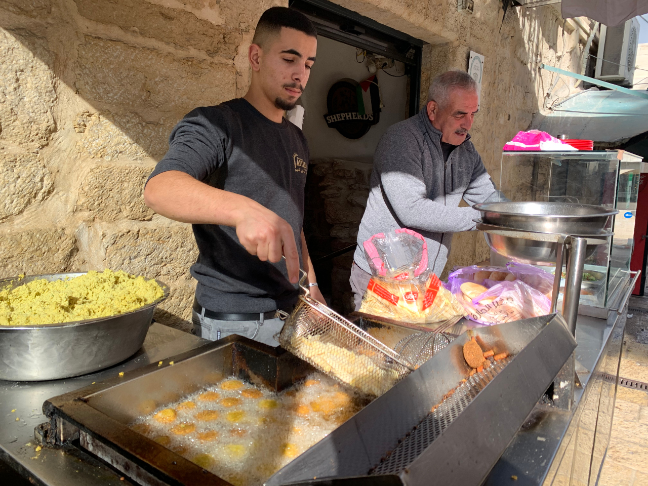 Afteem restaurant owner Saliba Salameh, right, said he had high hopes for the return of tourism to Bethlehem this year, but those hopes had been dashed (MEE/Shatha Hammad)