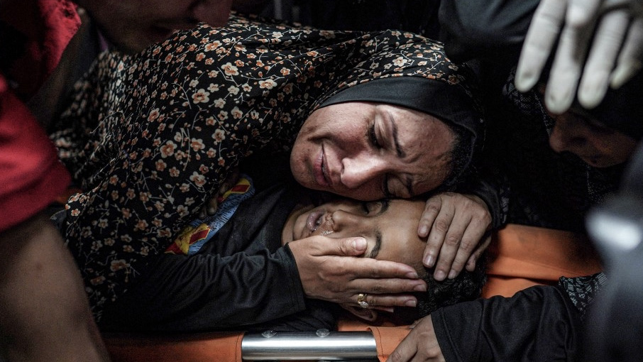 A woman mourns over the body of a child who was injured during bombardment on a displaced persons camp, at a trauma ward at the Aqsa Martyrs Hospital in Deir el-Balah in the central Gaza Strip on May 11, 2024. AFP.jpg